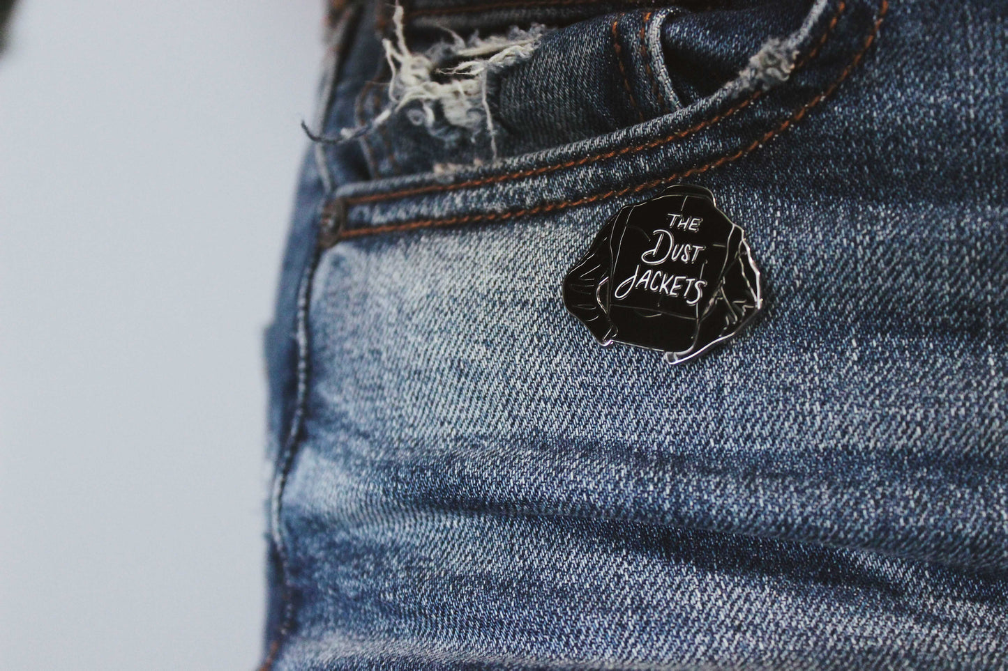 The Dust Jackets Enamel Pin
